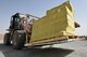 Senior Airman Quincy Petty, an inbound cargo journeyman assigned to the 386th Expeditionary Logistics Readiness Squadron, moves cargo at an undisclosed location in Southwest Asia, March 22, 2016. The 386th ELRS deployment and distribution flight is responsible packing, shipping and transporting cargo such as base supplies and equipment throughout the installation as well as to nearby bases. (U.S. Air Force photo by Staff Sgt. Jerilyn Quintanilla)