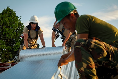 U.S. Air Force Senior Airman Josiah Sorrels, engineer, assigned to the 673D Expeditionary Engineer Squadron and a Philippine army soldier lay down thermal insulation at Jaena Norte Elementary School in Capiz, Philippines, as part of a humanitarian civic assistance (HCA) project during Exercise Balikatan 2016, April 2, 2016. The construction project is one of multiple HCAs taking place during this year's exercise, designed to improve the quality of life for the local populace and strengthen the bond between our two nations. Balikatan, which means "shoulder to shoulder" in Filipino, is an annual bilateral training exercise aimed at improving the ability of Philippine and U.S. military forces to work together during planning, contingency and humanitarian assistance and disaster relief operations. 