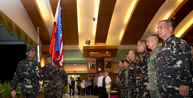 Flags from both nations are retired, during the opening ceremony of Balikatan 2016, aboard Camp Aguinaldo, April 4, 2016. Balikatan, which means "shoulder to shoulder" in Filipino, is an annual bilateral training exercise focused on improving the ability of Philippine and U.S. military forces to work together during planning, contingency and humanitarian assistance and disaster relief operations. This year marks the 32nd iteration of the exercise. (U.S. Marine Corps photo by Sgt. Erik Estrada)