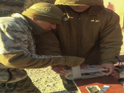 Marines from 3rd Platoon, Combat Engineer Company, Combat Assault Battalion, apply the finishing touches to a water charge used for breaching Jan. 28 at Rodriguez Live Fire Complex, Republic of Korea. The Marines were able to assemble and detonate several different styles of door and window charges in sub-zero temperatures. The Marines are from Combat Assault Battalion, 3rd Marine Division, III Marine Expeditionary Force, forward deployed in the Pacific. 