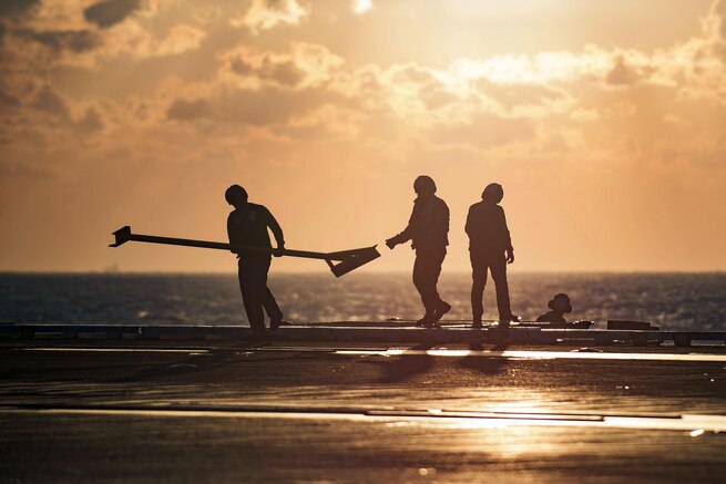 Sailors prepare to inspect jet blast deflectors on the flight deck of the aircraft carrier USS Dwight D. Eisenhower in the Atlantic Ocean, April 5, 2016. The Eisenhower is conducting a unit training exercise to prepare for a deployment. Navy photo by Petty Officer 3rd Class J. Alexander Delgado