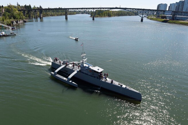 Sea Hunter, a new class of unmanned ocean-going vessel gets underway on the Williamette River, Portland, Ore., April 7, 2017, following a christening ceremony attended by Deputy Defense Secretary Bob Work. The vessel is part the of the Defense Advanced Research Projects Agency‘s Anti-Submarine Warfare Continuous Trail Unmanned Vessel program. Navy photo by John F. Williams