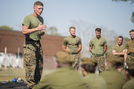 Sgt. John Taylor, a black belt Martial Arts Instructor with 2nd Transportation Support Battalion, 2nd Marine Logistics Group, leads Canadian cadets in a guided discussion about the Marine Corps' core values following a Marine Corps Martial Arts Program demonstration at Camp Lejeune, N.C., March 16, 2016.  A total of 46 cadets with the Argyll and Sutherland Highlanders of Canada Regimental Cadet Corps visited the base and multiple units as part of an educational tour to better understand how foreign militaries function. 