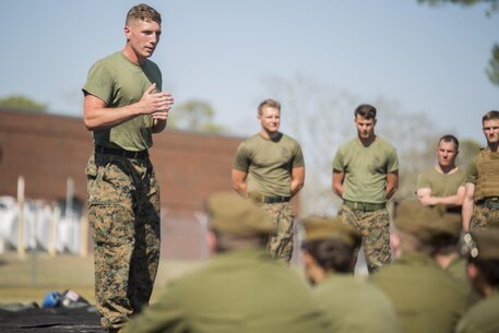 Sgt. John Taylor, a black belt Martial Arts Instructor with 2nd Transportation Support Battalion, 2nd Marine Logistics Group, leads Canadian cadets in a guided discussion about the Marine Corps' core values following a Marine Corps Martial Arts Program demonstration at Camp Lejeune, N.C., March 16, 2016.  A total of 46 cadets with the Argyll and Sutherland Highlanders of Canada Regimental Cadet Corps visited the base and multiple units as part of an educational tour to better understand how foreign militaries function. 
