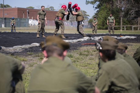 Marines with 2nd Marine Logistics Group show the intensity behind trench warfare by conducting a pugil sticks scrimmage at Camp Lejeune, N.C., March 16, 2016. A total of 46 cadets with the Argyll and Sutherland Highlanders of Canada Regimental Cadet Corps visited the base and multiple units as part of an educational tour to better understand how foreign militaries function. 