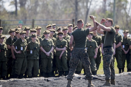 U.S. Navy Petty Officer 3rd Class Christopher Marlo, a hospital corpsman and black belt Martial Arts Instructor with 2nd Medical Battalion (right), breaks down the movements used to counter a knife attack at Camp Lejeune, N.C., March 16, 2016. A total of 46 cadets with the Argyll and Sutherland Highlanders of Canada Regimental Cadet Corps visited the base and multiple units as part of an educational tour to better understand how foreign militaries function. 