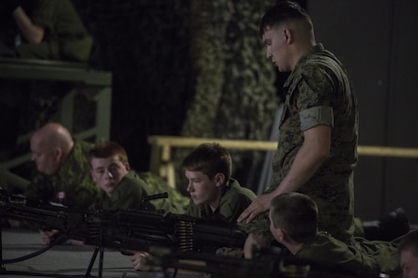 Lance Cpl. Luke Dailey, an indoor simulated marksmanship trainer with the Battle Skills Training School, operated by the 2nd Marine Logistics Group, helps a Canadian cadet diagnose a misfire at Camp Lejeune, N.C., March 15, 2016. A total of 46 cadets with the Argyll and Sutherland Highlanders of Canada Regimental Cadet Corps visited the base and multiple units as part of an educational tour to better understand of how foreign militaries function. (U.S. Marine Corps photo by Lance Cpl. Preston McDonald/Released)