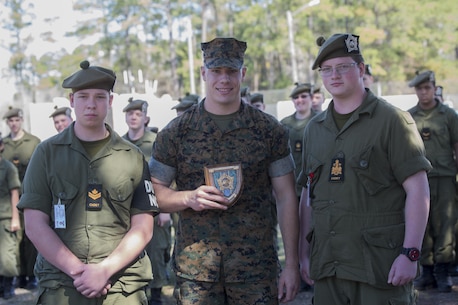 Cpl. Justin Zierer, an indoor simulated marksmanship trainer with the Battle Skills Training School, operated by the 2nd Marine Logistics Group, receives a plaque at Camp Lejeune, N.C., March 15, 2016. A total of 46 cadets with the Argyll and Sutherland Highlanders of Canada Regimental Cadet Corps visited the base and multiple units as part of an educational tour to better understand of how foreign militaries function. (U.S. Marine Corps photo by Lance Cpl. Preston McDonald/Released)