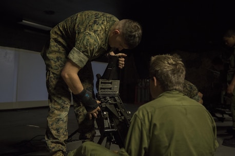 Lance Cpl. Luke Dailey, an indoor simulated marksmanship trainer with the Battle Skills Training School, operated by the 2nd Marine Logistics Group, teaches a Canadian cadet how to load a MK19 40mm grenade launcher at Camp Lejeune, N.C., March 15, 2016. A total of 46 cadets with the Argyll and Sutherland Highlanders of Canada Regimental Cadet Corps visited the base and multiple units as part of an educational tour to better understand of how foreign militaries function. (U.S. Marine Corps photo by Lance Cpl. Preston McDonald/Released)