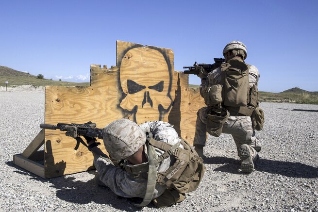 Marine Corps Lance Cpl. Corey Johnson, left, and Lance Cpl. Daniel Lopez fire their M4 carbines from behind a barricade during a combat marksmanship training at Camp Pendleton, Calif., March 31, 2016. The event aims to hone combat marksmanship skills, including how to shoot, move and communicate with a buddy. Johnson and Lopez are mortarmen assigned to the 1st Marine Division's Weapons Company, 3rd Battalion, 1st Marine Regiment. Marine Corps photo by Cpl. Garrett White
