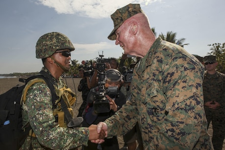 U.S. Marine Corps Lt. Gen. John A. Toolan, commander of the U.S. Marine Corps Forces, Pacific, greets a Philippine marine, member of the Joint Rapid Reaction Force (JRRF), after executing an amphibious landing to seize a scenario-based objective as part of Exercise Balikatan 2016, in Antique, Philippines, April 11, 2016. The JRRF, compiled of U.S. and Philippine forces, have worked together during the exercise to test their capabilities, maintain a high level of interoperability and to enhance combined combat readiness. Balikatan, which means "shoulder to shoulder" in Filipino, is an annual bilateral training exercise aimed at improving the ability of Philippine and U.S. military forces to work together during planning, contingency and humanitarian assistance and disaster relief operations. 