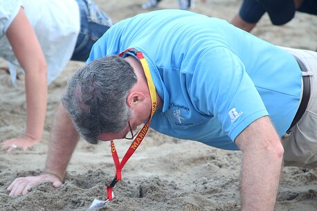 Charlie Crabtree, coach from Mary G. Montgomery high school, does push-ups in the sand with other educators from the greater Montgomery area aboard Marine Corps Recruit Depot Parris Island, S.C., April 13, 2016. The teachers, coaches, and principals of Recruiting Stations Jacksonville and Montgomery participate in a three-day workshop designed to inform educators about military service and life in the Marine Corps. (Official Marine Corps photo Cpl. John-Paul Imbody)