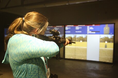 Cheryl Bynum, counselor at Horsemore Bend High School, prepares to practice using an M16 at the Indoor Simulated Marksmanship Training facility aboard Marine Corps Recruit Depot Parris Island, S.C., April 13, 2016. The teachers, coaches, and principals of Recruiting Stations Jacksonville and Montgomery participate in a three-day workshop designed to inform educators about military service and life in the Marine Corps. (Official Marine Corps photo Cpl. John-Paul Imbody)