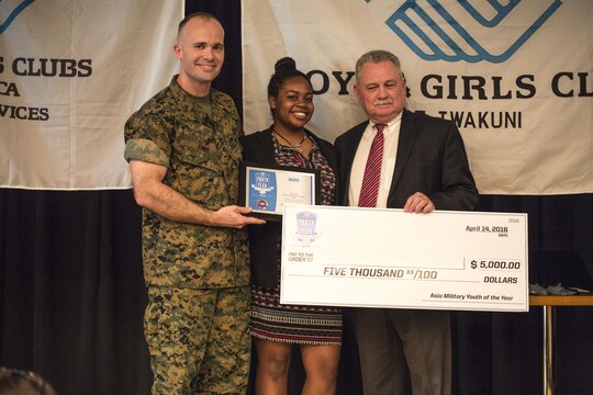 Maya Pugh, a teen from Yokosuka Naval Base, receives the 2016 Asia Military Youth of the Year Award  during the 2016 Asia Keystone Conference at Marine Corps Air Station Iwakuni, Japan, April 13, 2016. Teens from across the pacific region gathered to find out the winner of the 2016 Asia Military Youth of the Year Award. (U.S. Marine Corps photo by Cpl. Nathan Wicks/Released)