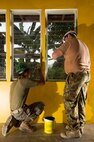 Australian Army Sapper Scott Nolan, a carpenter from 21 Construction Squadron, 6th Engineer Support Regiment, right, and Lance Corporal Marco Rodriguez of the United States Marine Corps, paint a school building during Exercise Balikatan 2016.