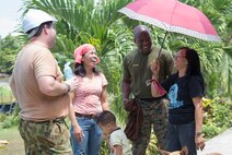 Australian Sapper Scott Nolan, a carpenter from 21 Construction Squadron, 6th Engineer Support Regiment, left, and Gunnery Sergeant Mark Francis of the United States Marine Corps laugh with local school teachers during Exercise Balikatan 2016. 