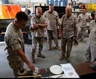 U.S. Marine Lt. Gen. David A. Berger and other high-level unit leaders receive a capabilities demonstration on 3-D printing technology aboard Camp Pendleton, Calif., April 6, 2016. Berger is the commanding general of I Marine Expeditionary Force. Marines with 1st Maintenance Battalion, Combat Logistics Regiment 15, 1st Marine Logistics Group, demonstrated the potential of 3-D printing capabilities to the commanders of I MEF and 1st MLG. Still in the testing phase, the battalion has already discovered endless possibilities as to how they can integrate the technology into their mission. (U.S. Marine Corps photo by Cpl. Carson Gramley/released)