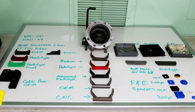 Replacement parts created using 3-D printing technology are displayed next to original parts as an example to the accuracy of the equipment during a demonstration aboard Camp Pendleton, Calif., April 6, 2016. 1st Maintenance Battalion, Combat Logistics Regiment 15, 1st Marine Logistics Group, demonstrated the potential of 3-D printing capabilities to the commanders of I Marine Expeditionary Force and 1st MLG. Still in the testing phase, the battalion has already discovered endless possibilities as to how they can integrate the technology into their mission. (U.S. Marine Corps photo by Cpl. Carson Gramley/released)