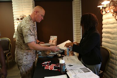 U.S. Marine Gunnery Sgt. Raul Padronmartin reads a pamphlet at a family advocacy booth during the 101 days of summer campaign kick-off event aboard Camp Pendleton, Calif., April 11, 2016. Padronmartin is a maintenance chief with 1st Maintenance Battalion, 1st Marine Logistics Group.  Leaders within 1st MLG stressed the importance of taking care of their own and taking the time to know their Marines. Various organizations directed at supporting and enriching service members’ lives had pamphlets and helpful information readily available for all who attended. (U.S. Marine Corps photo by Sgt. Laura Gauna/released)