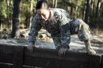 Spc. Kayla Bundy, 1st Bn., 414th Inf. Reg., 95th Training Division (IET), hurdles a wall on the fit-to-win endurance obstacle course during the 2016 108th Training Command (IET) Best Warrior competition held at Fort Jackson, S.C., March 21. This year's Best Warrior competition determined the top NCO and junior enlisted Soldier who will represent the 108th Training Command (IET) at the Army Reserve Drill Sgt. of the Year competition later this year at Fort Bragg, N.C. Bundy was selected to represent the 108th in the junior enlisted competition. (U.S. Army photo by Sgt. 1st Class Brian Hamilton/released)