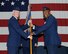 Col. James Boster, 14th Operations Group Commander, passes the 48th Flying Training Squadron guidon to Lt. Col. Charles Gilliam, the new 48th FTS Commander, during a change of command ceremony April 21 at Columbus Air Force Base, Mississippi. (U.S. Air Force photo/Elizabeth Owens)