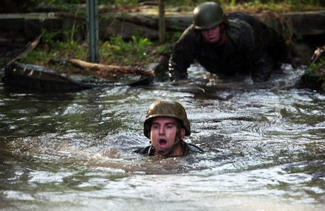 Gunnery Sgt. Joseph Janez, a career planner with Combat Logistics Regiment 2, swims through one of the deeper mud puddles during the endurance course at Camp Lejeune, N.C., April 22, 2016. The unit pushed through the grueling 3.4 mile course to improve their ability to work as a team and to build camaraderie.