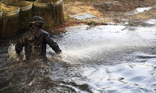 A Marine with Combat Logistics Regiment 2, makes his way through the final obstacle to exit an endurance course at Camp Lejeune, N.C., April 22, 2016. The unit pushed through the grueling 3.4 mile course to improve their ability to work as a team and to build camaraderie.