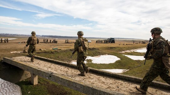 U.S. Marines with Black Sea Rotational Force move up range after reviewing the shot groups of their M240B light machine guns during a live-fire exercise aboard Mihail Kognalniceanu Air Base, Romania, Feb. 2, 2016. Marines from 1st Battalion, 8th Marine Regiment, conducted battle sight zeroes on various individual weapons systems, to prepare for future BSRF exercises and contingencies. 