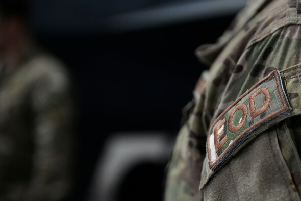 A U.S. Airman displays an explosive ordnance disposal brassard on the left shoulder of his uniform during F-16CM Fighting Falcon explosive mitigation training at the 20th Maintenance Group weapon standardization and evaluation hangar, April 22, 2016, at Shaw Air Force Base, S.C. EOD Airmen perform F-16 explosive mitigation training to prepare in the event that an F-16 has a munitions malfunction. (U.S. Air Force photo by Airman 1st Class Christopher Maldonado)