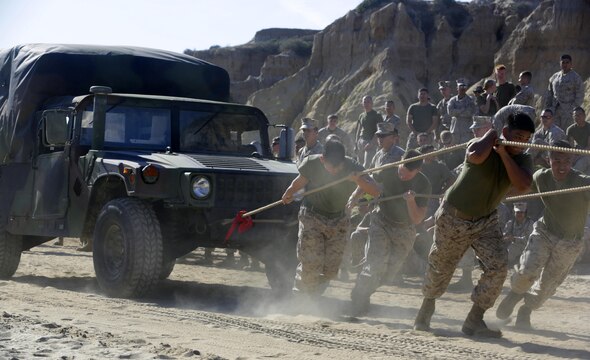 Marines with different sections within Headquarters and Headquarters Squadron, Marine Corps Air Station Camp Pendleton compete in a High Mobility Multipurpose Wheeled Vehicle Pull against each other, which is one of the many different Warrior Night events at Red Beach, Camp Pendleton, April 22, 2016. The Warrior Night is a way for Marines in a unit to come together and enjoy each other’s company to harden camaraderie and espirit de corps. (Marine Corps Photo by Lance Cpl. Emmanuel Necoechea)