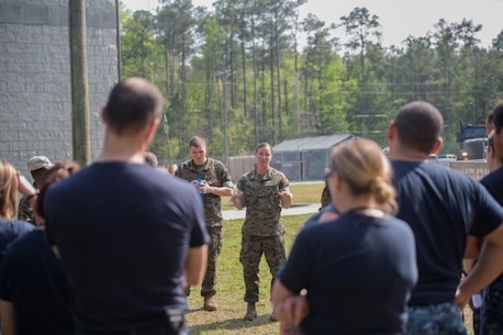 Navy Lt. Lani Kuhlow, a Health Service Augmentation Program instructor, debriefs sailors following a medical scenario at Camp Lejeune, N.C., April 20, 2016. Sailors with the Camp Lejeune Naval Hospital were put through a week-long HSAP training exercise, where they were required to familiarize themselves with the gear and operations of a shock trauma platoon in a deployed environment.