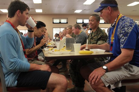 Educators have a meal with Recruit Tsz Chuen Lam from Platoon 2045, Golf Company and ask questions about recruit training aboard Marine Corps Recruit Depot Parris Island, S.C., April 27, 2016. The teachers, coaches, and principals of Recruiting Stations Nashville and Baton Rouge participate in a three-day workshop designed to inform educators about military service and life in the Marine Corps. Lam is a native of Hong Kong, China, and was recruited out of Brooklyn, N.Y.,. (Official Marine Corps photo Cpl. Diamond N. Peden)