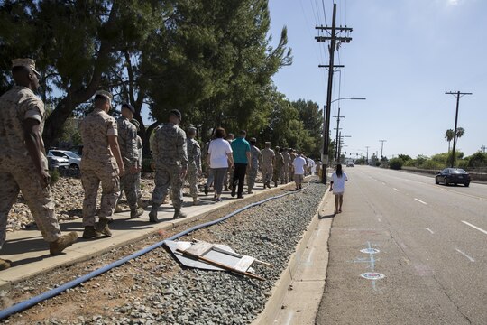 Service members and volunteers participate in the 2016 Sexual Assault Prevention and Response Walk aboard Marine Corps Air Station Miramar, Calif., April 22. The walk helped spread awareness on the topic of sexual assault and how important it is to get rid of it. (U.S. Marine Corps photo by Sgt. Michael Thorn/Released)