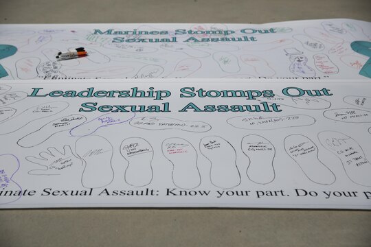 Two banners are placed on the ground for display after the 2016 Sexual Assault Prevention and Response Walk aboard Marine Corps Air Station Miramar, Calif., April 22. The banners were held by Marines during the walk to help spread awareness on sexual assault. (U.S. Marine Corps photo by Sgt. Michael Thorn/Released)