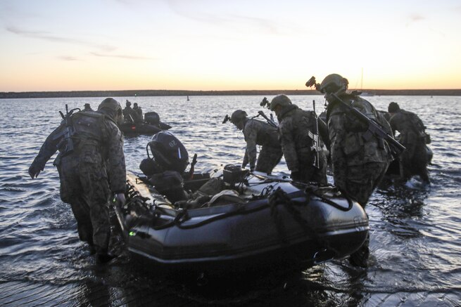 Marines carry a combat raiding craft into the water to conduct beach searches during an amphibious operations training exercise at Camp Pendleton, Calif., April 21, 2016. Marine Corps photo by Cpl. Demetrius Morgan