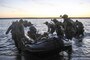 Marines carry a combat raiding craft into the water to conduct beach searches during an amphibious operations training exercise at Camp Pendleton, Calif., April 21, 2016. Marine Corps photo by Cpl. Demetrius Morgan