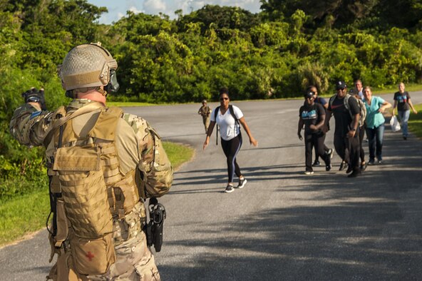 A deployed aircraft ground response element (DAGRE) Airman, assigned to the 353rd Special Operations Support Squadron, stops a group of simulated refugees to search before boarding them onto an aircraft during an exercise at Kadena Air Base, Japan, July 27, 2016. The DAGRE team must master a wide range of special operations missions, so they routinely practice different scenarios they might encounter. (U.S. Air Force photo by Airman 1st Class Corey M. Pettis)