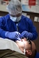 Staff Sgt. Nathaniel Farinas, 14th Medical Operations Squadron Dental Technician, performs a routine cleaning on a patient’s mouth July 29 at Columbus Air Force Base, Mississippi. The Dental Flight can provide education on prevention, show patients how to brush properly, how to and how many times a day to floss and recommendations on toothpaste and rinsing aids. (U.S. Air Force photo/Airman 1st Class John Day)