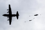 U.S. Army paratroopers perform an airborne insertion from a C-130 Hercules during Red Flag-Alaska at Joint Base Elmendorf-Richardson, Alaska, Aug 10, 2016. After a four-hour flight through simulated enemy controlled territory 80 soldiers jumped from multiple aircraft to control the drop zone. (U.S. Air Force photo by Staff Sgt. Michael Smith/Released)