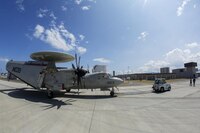 A U.S. Navy E-2C Hawkeye assigned to Carrier Airborne Early Warning Squadron 115, with Carrier Air Wing 5, taxis into hot refueling pits at Marine Corps Air Station Iwakuni, Japan, Aug. 17, 2016. While passing through the air station for aircraft-based training, maintainers inspected and refueled the Hawkeyes before their retrograde back to Naval Air Facility Atusgi. 