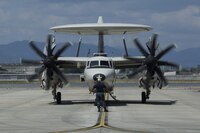 A U.S. Navy E-2C Hawkeye assigned to Carrier Airborne Early Warning Squadron 115, with Carrier Air Wing 5, taxis into hot refueling pits at Marine Corps Air Station Iwakuni, Japan, Aug. 17, 2016. While passing through the air station for aircraft-based training, maintainers inspected and refueled the Hawkeyes before their retrograde back to Naval Air Facility Atusgi. 