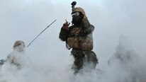 Maj. Christopher W. Simpson, commanding officer, Company C with 1st Battalion, 1st Marine Regiment, dons a mask while surrounded by CS gas during a live fire range August 18, 2016 at Bradshaw Field Training Area, Northern Territory, Australia. The range was the final training evolution of Exercise Koolendong 16, a trilateral exercise between the U.S. Marine Corps, Australian Defence Force and French Armed Forces New Caledonia. Marines held a defensive position while engaging targets and working through the CS gas, which simulated a chemical attack.