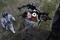 Army Spc. Mariah Ridge, a military working dog handler, and her dog, Jaska, ride a hoist to a UH-60L Black Hawk helicopter during K-9 hoist evacuation training at Soto Cano Air Base, Honduras, Aug. 15, 2016. Ridge is assigned to Joint Task Force Bravo’s Joint Security Forces. Air Force photo by Staff Sgt. Siuta B. Ika
