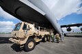 U.S. and Canadian soldiers discuss different techniques and methods for uploading vehicles onto an Canadian air force Globemaster III aircraft in Greenville, S.C., Aug. 13, 2016. Army National Guard photo by Staff Sgt. Roby Di Giovine