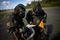 U.S. Marines with 3rd Marine Regiment mark off an area during the Chemical, Biological, Radiological, and Nuclear Reconnaissance and Surveillance Training Course at Marine Corps Training Area Bellows, Hawaii, Aug. 10, 2016. Select Marines within the Regiment under-went the training designed to equip them with the capability to confirm or deny CBRN presence on the battlefield.