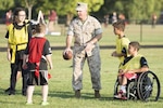Marine Corps Sgt. Maj. Craig D. Cressman plays flag football with children during an NFL Play 60 event at Fort Belvoir, Va., Sept. 30, 2014. Army photo by Rachel Larue