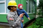 Army Spc. Raven Henderson, assigned to the 375th Engineer Company, 467th Engineer Battalion, 926th Engineer Brigade, 412th Theater Engineer Command, holds a child from Kudikiu Namai during a Humanitarian Civil Assistance project in Sauliai, Lithuania, Aug. 18, 2016. Photo by Pfc. Emily Houdershieldt