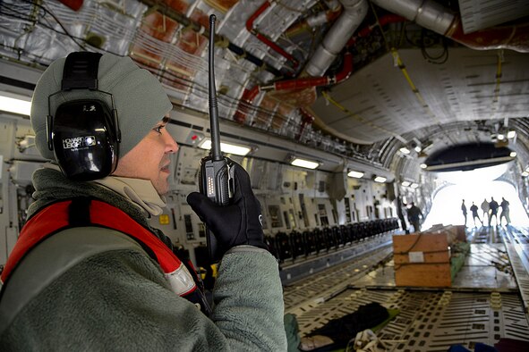 Staff Sgt. Jason Decena, 731st Air Mobility Squadron Air Terminal Operations Center controller, radios personnel after checking cargo on a C-17 Globemaster on Osan Air Base, Republic of Korea, Feb. 1, 2016. The ATOC Airmen here process more than 1,200 service members and their dependents and from 800 to 1,000 tons of cargo weekly. (U.S. Air Force photo by Senior Airman Kristin High/Released)