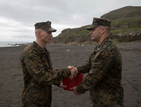 U.S. Marine Corps Sgt. Cody R. Gannon, a mortarman with Bravo Company, 1st Battalion, 2nd Marine Regiment, is meritoriously promoted by Lt. Col. Eric A. Reid, the battalion commander of 1/2, on Iwo Jima, Japan, Feb. 2, 2016. Gannon won the 2nd Marine Division Meritorious Sergeant Board and is currently forward deployed in the Pacific as part of 3rd Marine Division. (U.S. Marine Corps photo by MCIPAC Combat Camera Lance Cpl. Robert Gonzales/Released)