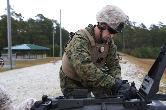 Lance Cpl. Austin Cable loads ammunition into an MK19 during a grenade and MK19 Grenade Launcher range at Marine Corps Base Camp Lejeune, N.C., Oct. 28, 2015. More than 70 Marines with 2nd Low Altitude Air Defense Battalion took turns handling the MK19 and handheld grenades during the familiarization range. The range offered Marines the opportunity to build confidence and proficiency skills on some of the crew-served weapons they operate while providing security in a deployed environment. Cable is a low altitude aerial defense gunner with the battalion. (U.S. Marine Corps photo by Cpl. N.W. Huertas/Released)